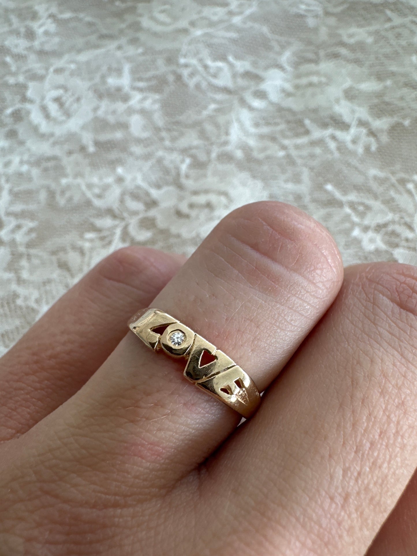 vintage 14k yellow gold "love" ring with diamond accent